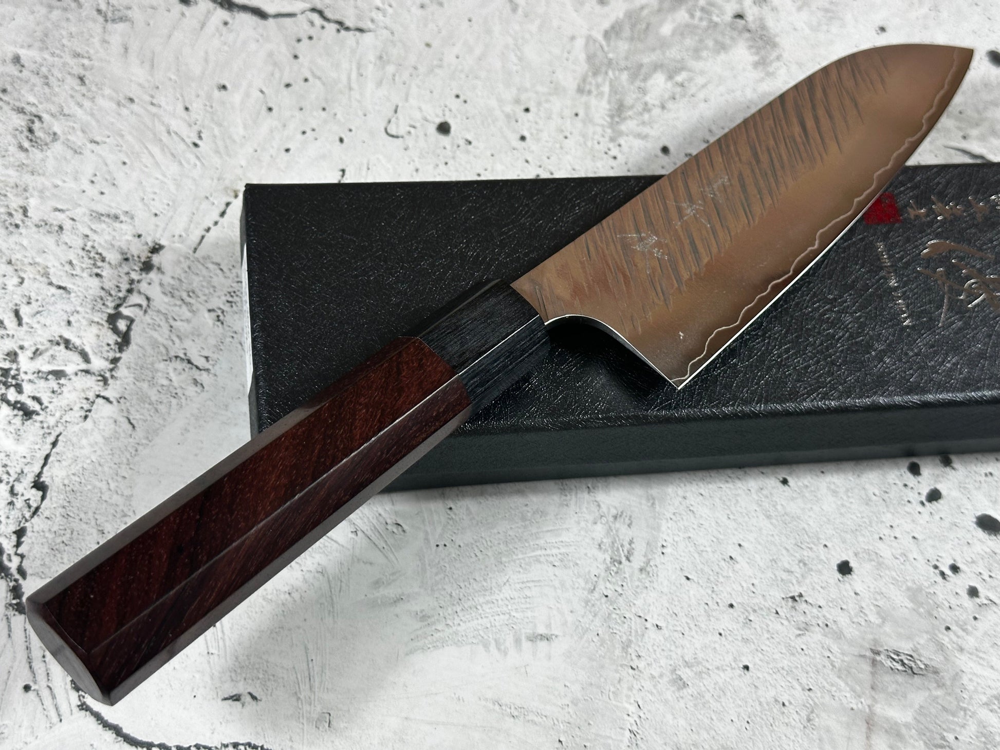 Knife with a wooden handle on a textured surface